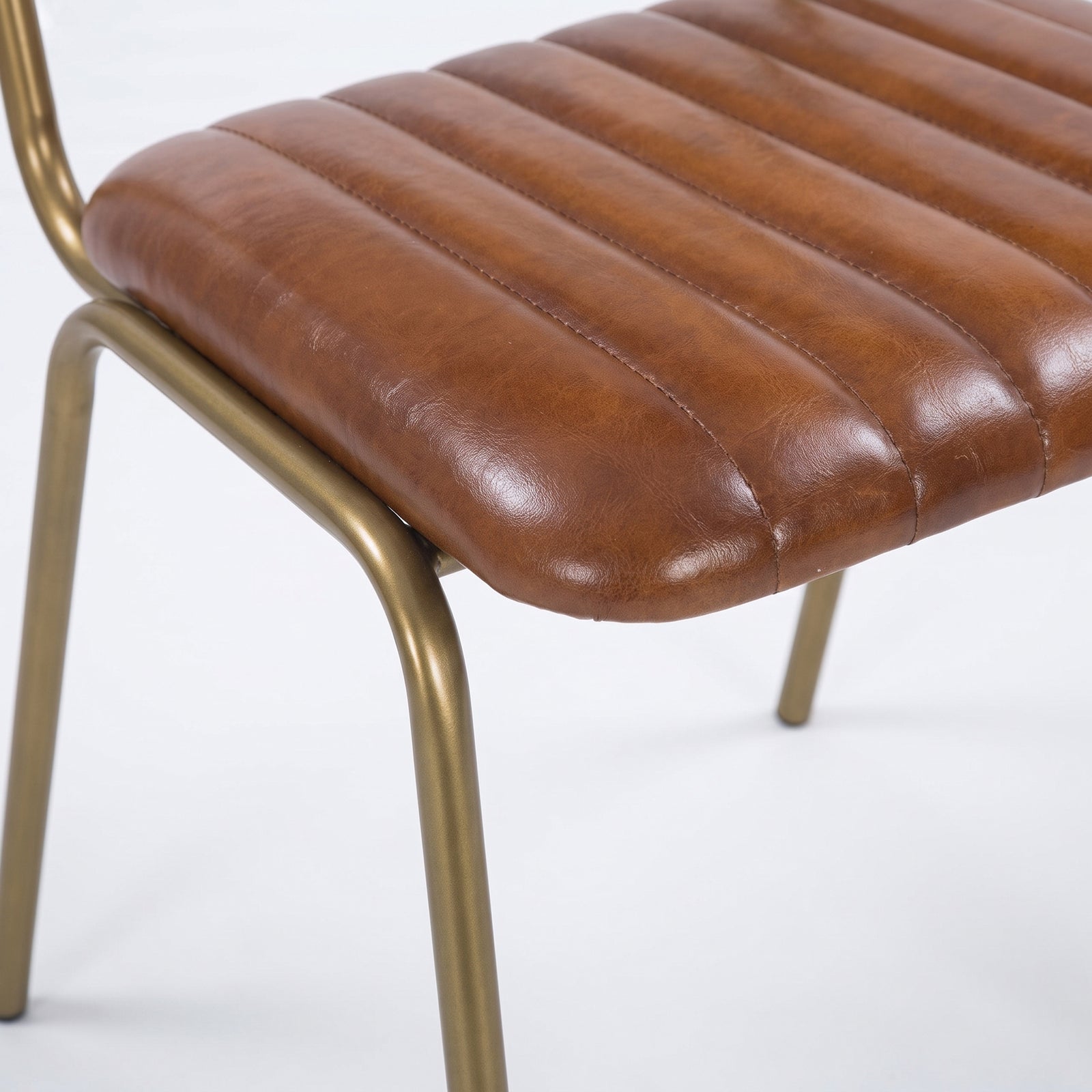 Détail de l'assise en cuir marron et du piètement de la chaise Arsène - Maison Pavane