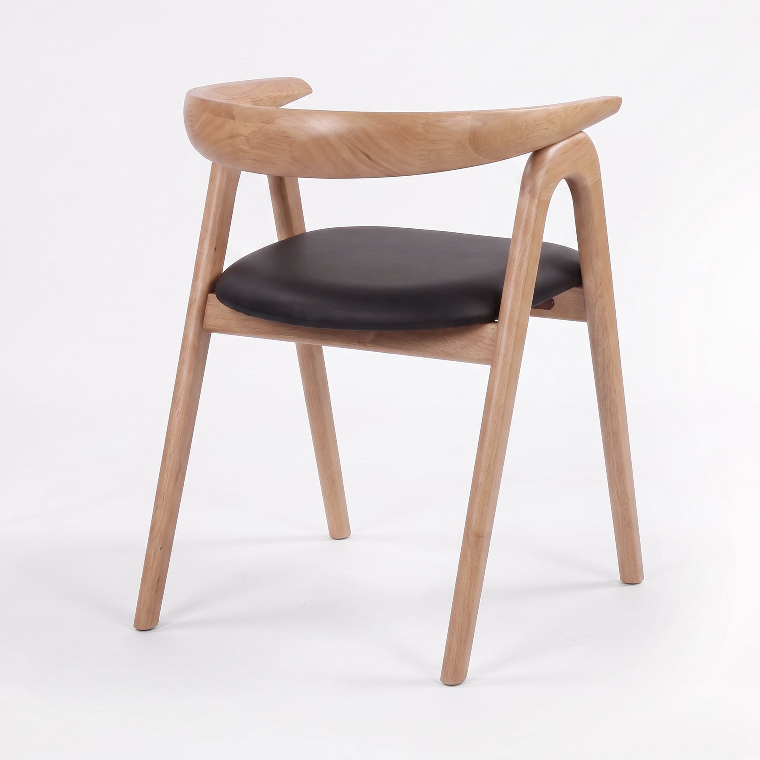 Chaise Hawa en bois d'hévéa blond et cuir synthétique noir, vue de trois-quarts arrière - Maison Pavane